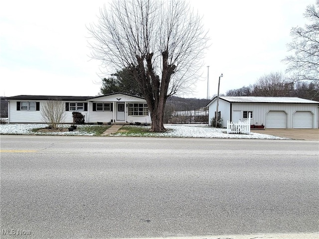 view of front facade featuring an outbuilding and a garage