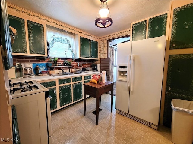 kitchen with backsplash, decorative light fixtures, white appliances, and sink