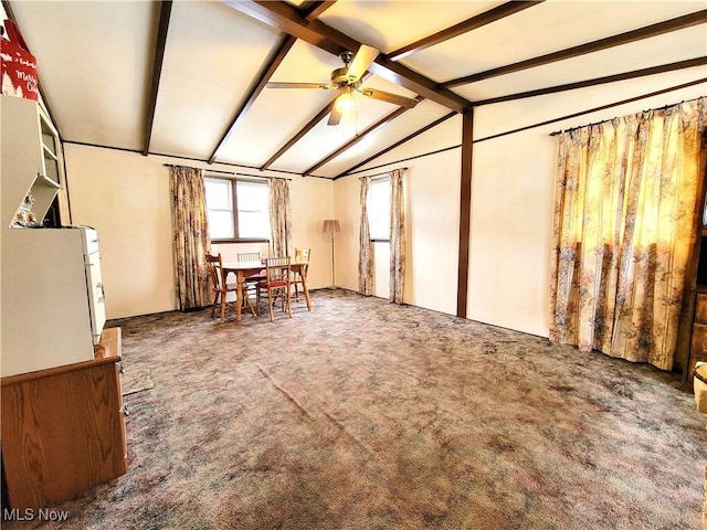 interior space with ceiling fan and lofted ceiling with beams