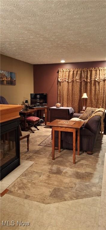 living area with a textured ceiling