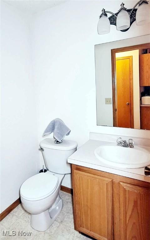 bathroom featuring tile patterned floors, vanity, and toilet