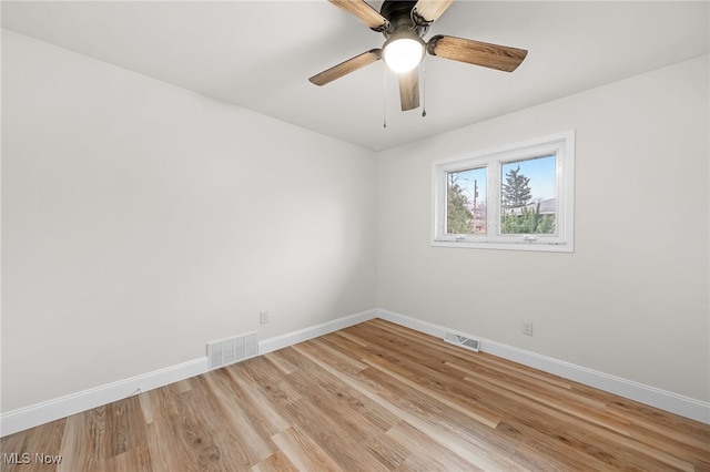 empty room featuring ceiling fan and light hardwood / wood-style flooring