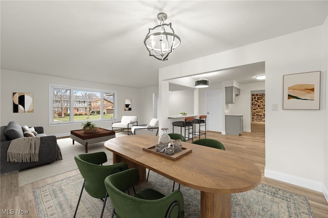 dining space featuring a chandelier and light hardwood / wood-style floors