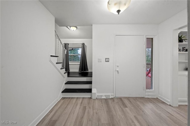 foyer entrance with light wood-type flooring