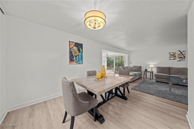 dining space with light hardwood / wood-style flooring