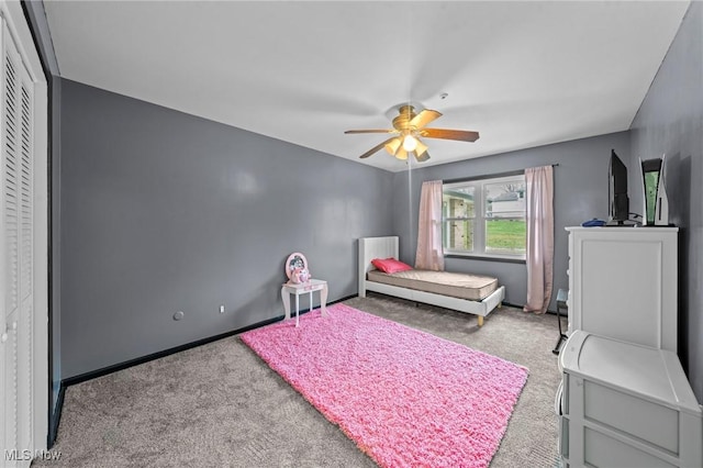 bedroom with light carpet, a ceiling fan, and baseboards