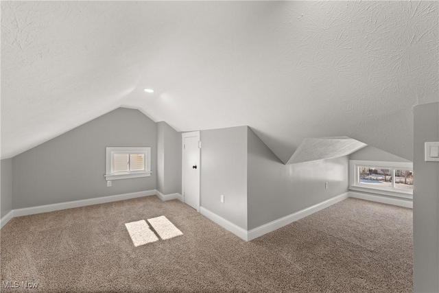 bonus room with a wealth of natural light, carpet floors, and vaulted ceiling