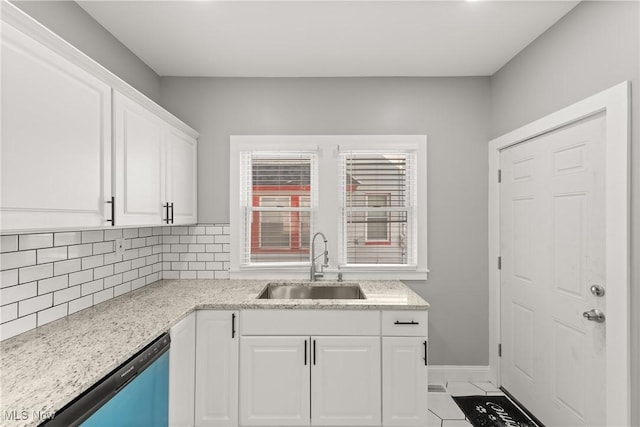 kitchen with decorative backsplash, white cabinetry, sink, and dishwasher