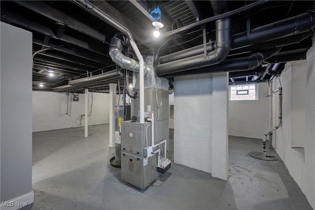 basement featuring heating unit and water heater