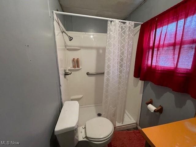 bathroom with toilet and walk in shower