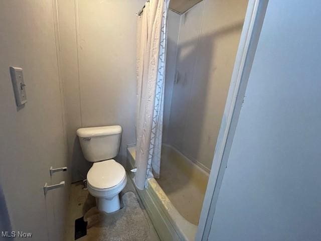 bathroom with toilet and curtained shower