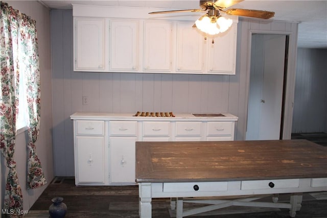 kitchen with dark hardwood / wood-style flooring, white cabinetry, and ceiling fan