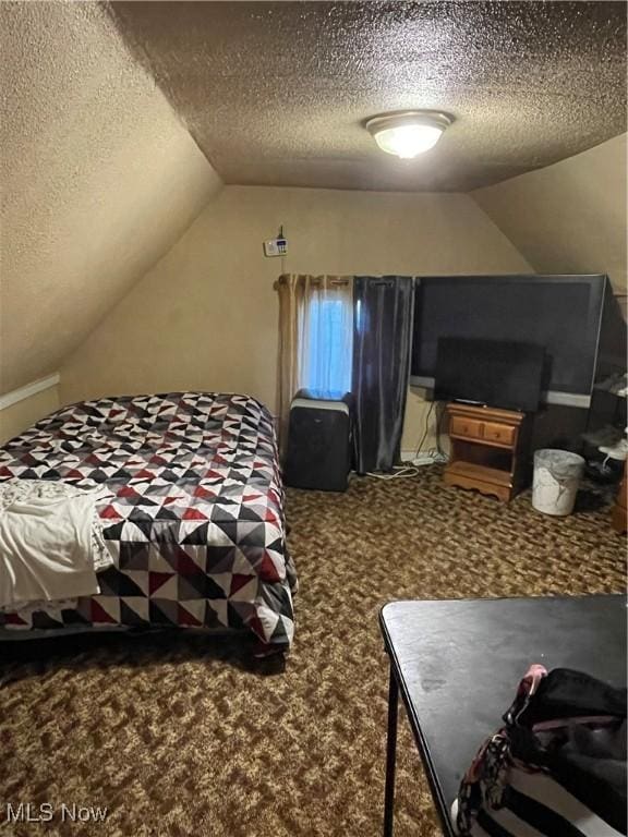 carpeted bedroom with a textured ceiling and lofted ceiling