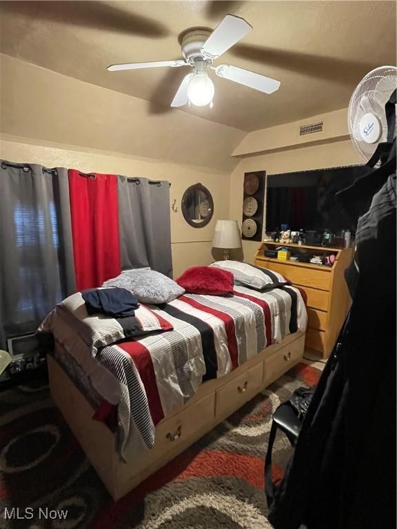 bedroom featuring ceiling fan and lofted ceiling