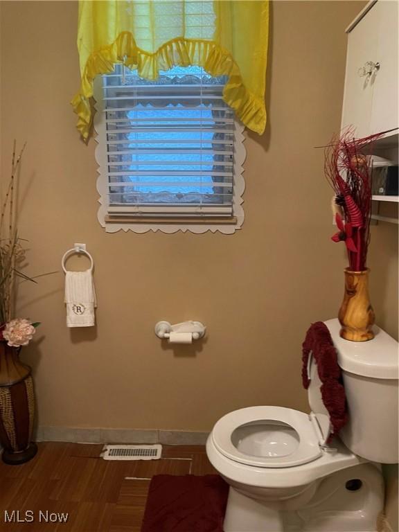 bathroom featuring hardwood / wood-style floors and toilet