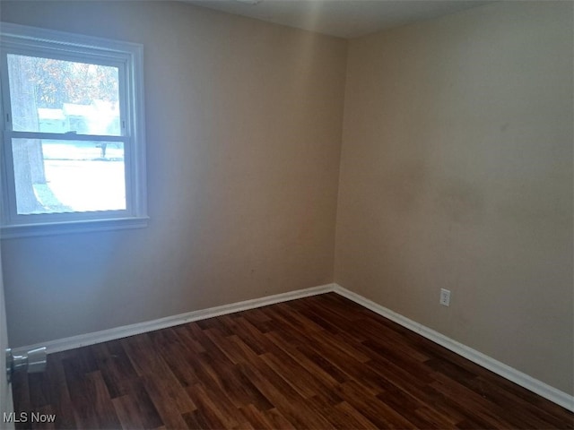 empty room with dark wood-type flooring