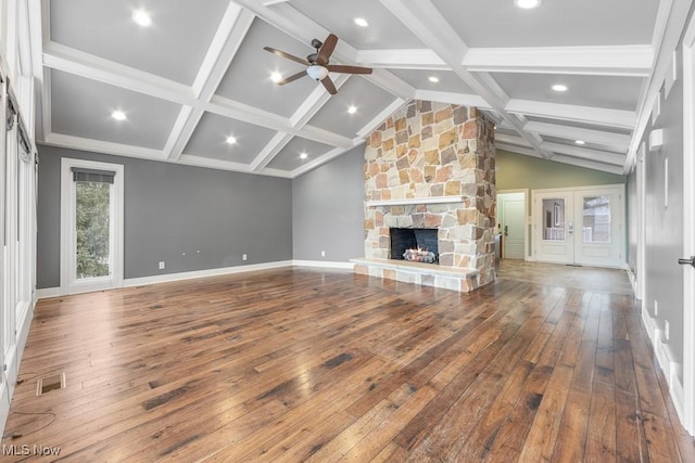 unfurnished living room featuring a fireplace, wood-type flooring, vaulted ceiling with beams, and ceiling fan