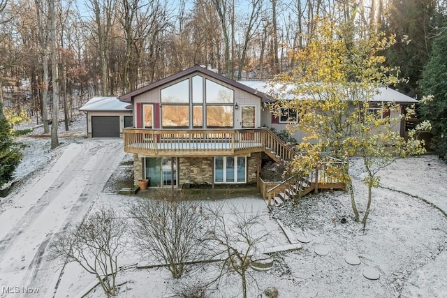 view of snow covered rear of property