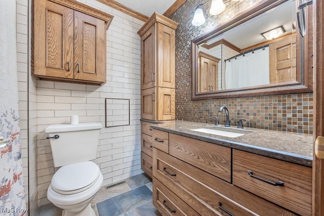 bathroom featuring walk in shower, tasteful backsplash, toilet, vanity, and ornamental molding