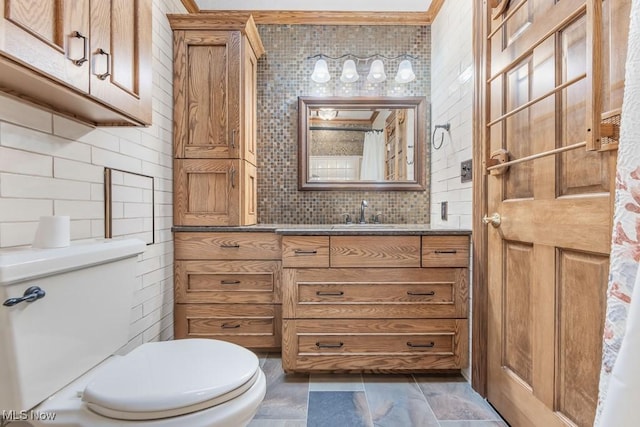 bathroom featuring vanity, backsplash, and toilet