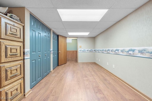 unfurnished room with wood-type flooring and a drop ceiling