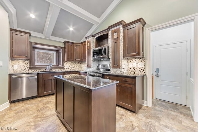 kitchen with a center island, lofted ceiling with beams, dark stone countertops, tasteful backsplash, and stainless steel appliances