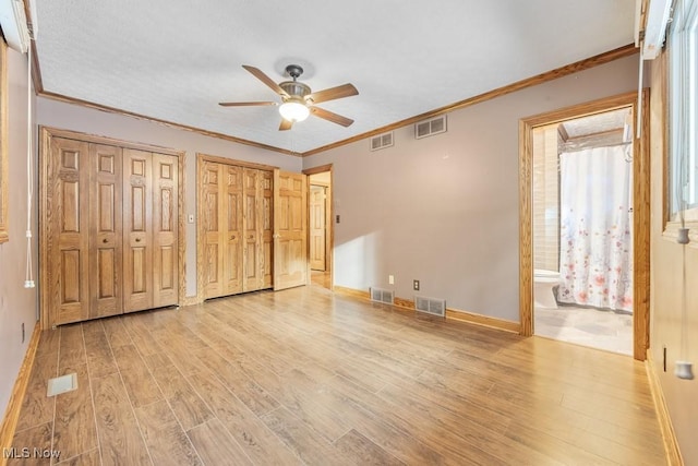 unfurnished bedroom with connected bathroom, ceiling fan, crown molding, and light hardwood / wood-style floors