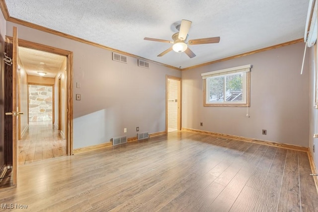 empty room featuring ceiling fan, crown molding, a textured ceiling, and hardwood / wood-style flooring