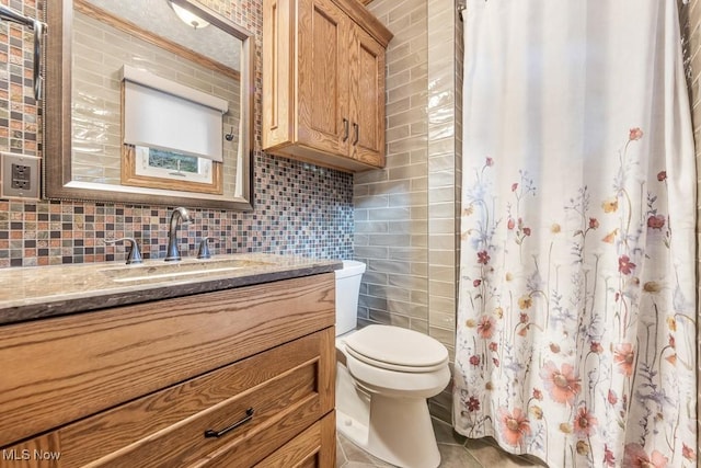 bathroom with vanity, tile walls, and tasteful backsplash