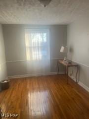 empty room featuring hardwood / wood-style flooring