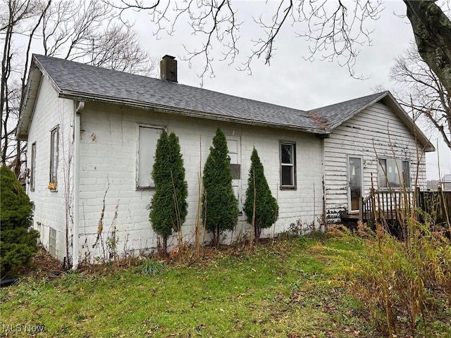 view of home's exterior with a lawn