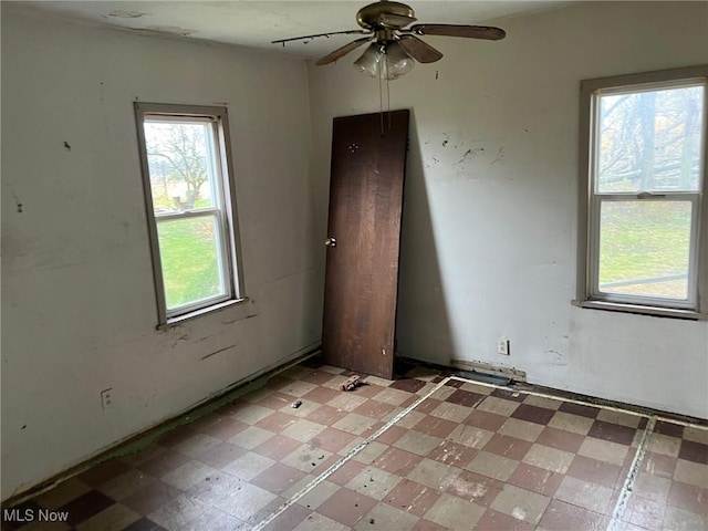 unfurnished room with ceiling fan