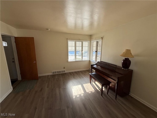 miscellaneous room featuring dark wood-type flooring