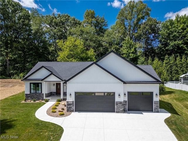 modern farmhouse with a front yard and a garage