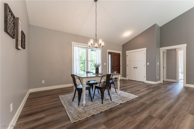 dining space with dark hardwood / wood-style flooring, high vaulted ceiling, and an inviting chandelier