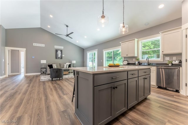 kitchen with gray cabinetry, dishwasher, light hardwood / wood-style flooring, decorative light fixtures, and white cabinetry