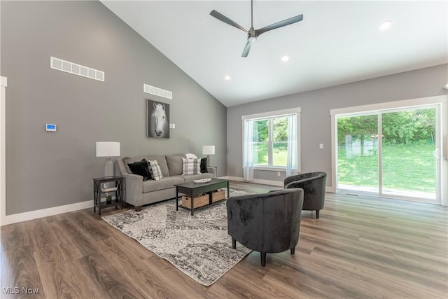 living room featuring hardwood / wood-style floors, high vaulted ceiling, and ceiling fan