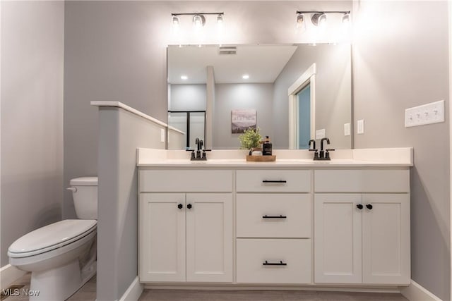 bathroom featuring vanity and toilet