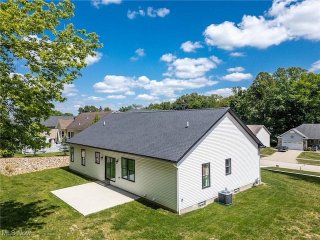 back of property featuring a lawn, a patio area, and central air condition unit