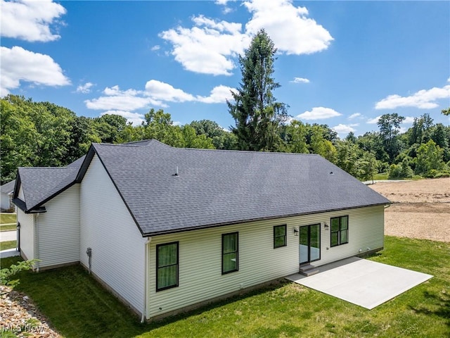 rear view of house with a patio area and a yard