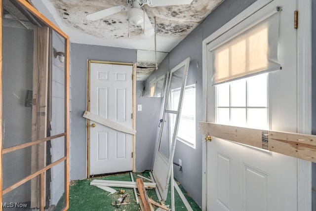 doorway to outside featuring ceiling fan