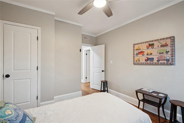 bedroom with hardwood / wood-style flooring, ceiling fan, and ornamental molding