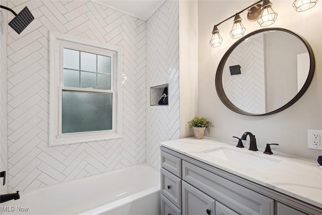 bathroom featuring vanity and tiled shower / bath combo