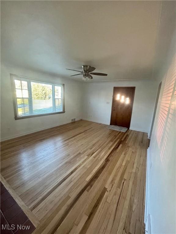 interior space with light wood-type flooring and ceiling fan