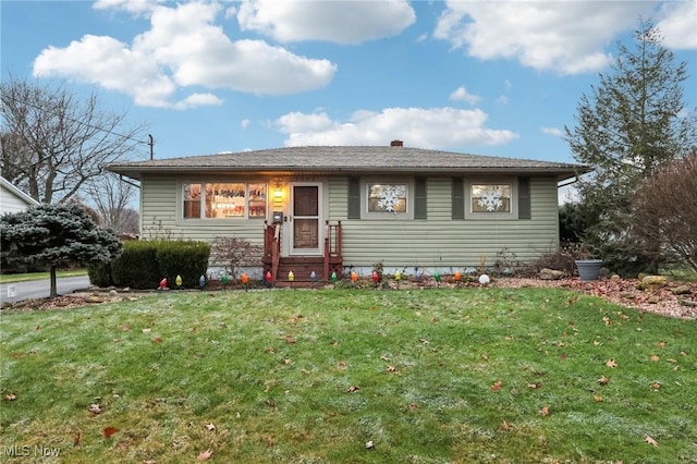 single story home featuring a front lawn