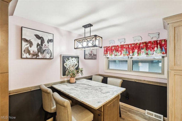 dining room featuring light hardwood / wood-style flooring and breakfast area