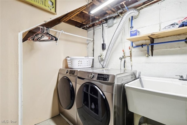 laundry room with independent washer and dryer and sink