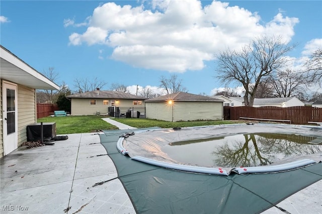 exterior space with an outdoor structure, a patio area, a yard, and a diving board