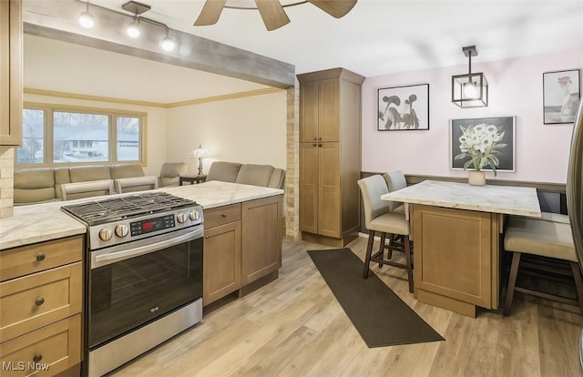 1503 Difford Dr, Niles, OH 44446 - kitchen with stainless steel range with gas cooktop, a kitchen bar, light wood finished floors, open floor plan, and light stone countertops