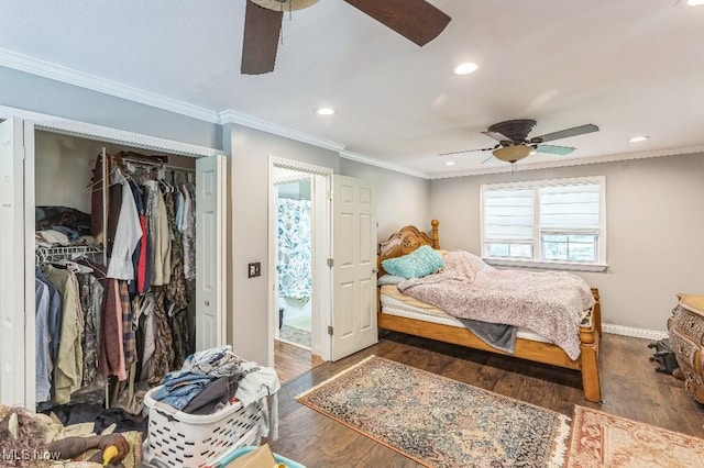 bedroom with ornamental molding, a closet, ceiling fan, and dark wood-type flooring